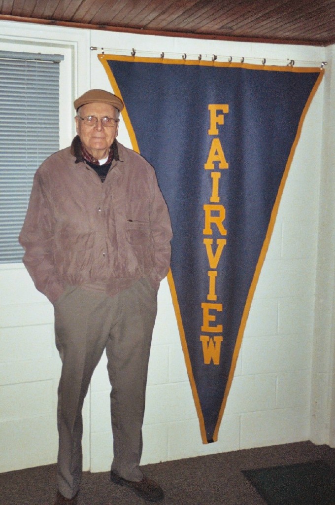 Herman Romeiser the Class of '40. He is standing next to an old FHS banner which hung at Nancy Marker's house. Herman and Nancy worked together on the Alumni Banquet.