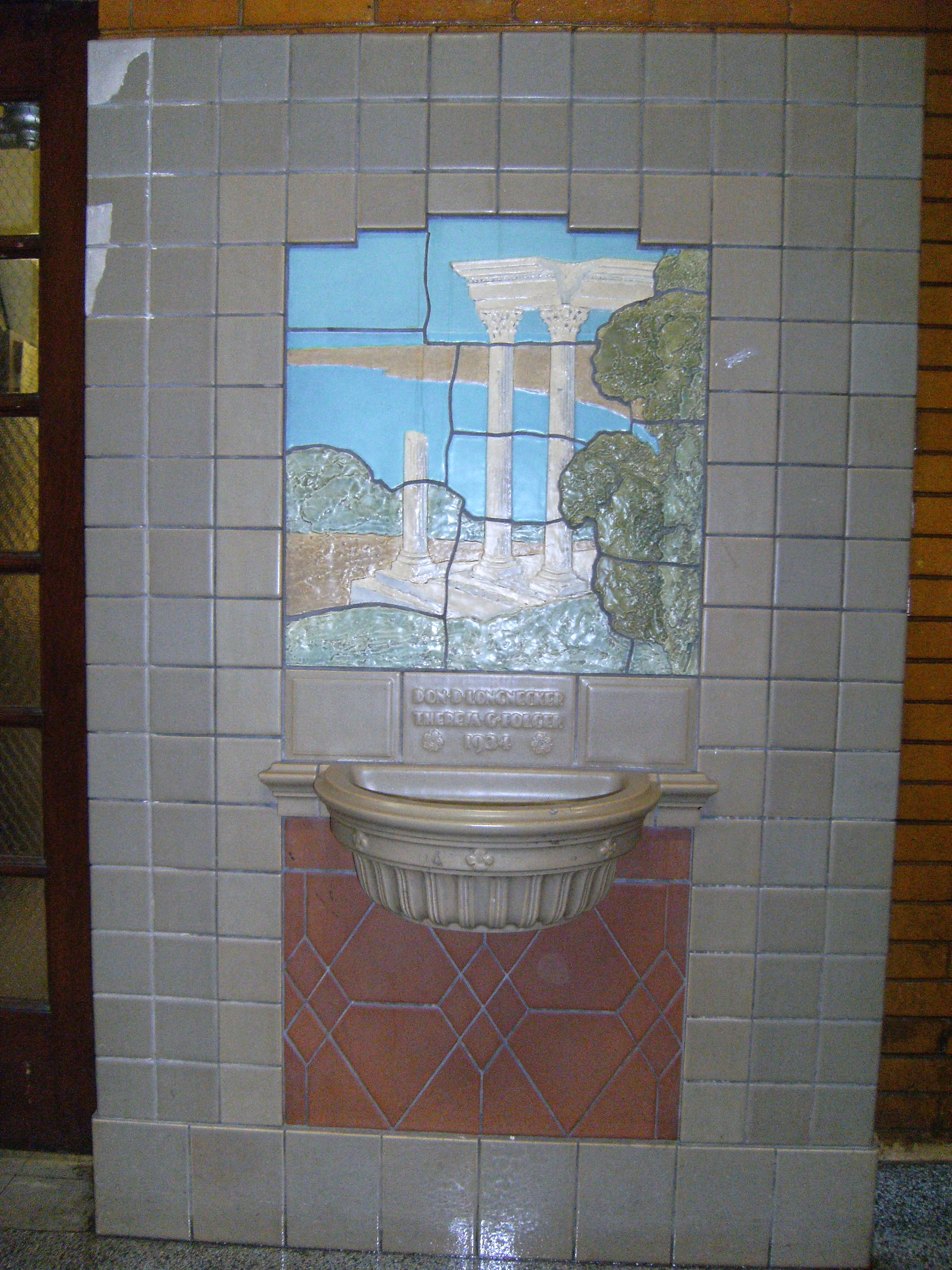 The Rookwood fountain located on the first floor near the middle stairway facing Hillcrest. Dedicated in 1934 to then Assistant Principal Miss Theresa Folger and Principal Don Longnecker. It was restored by Bob Mousaian and is now displayed at the new NW 