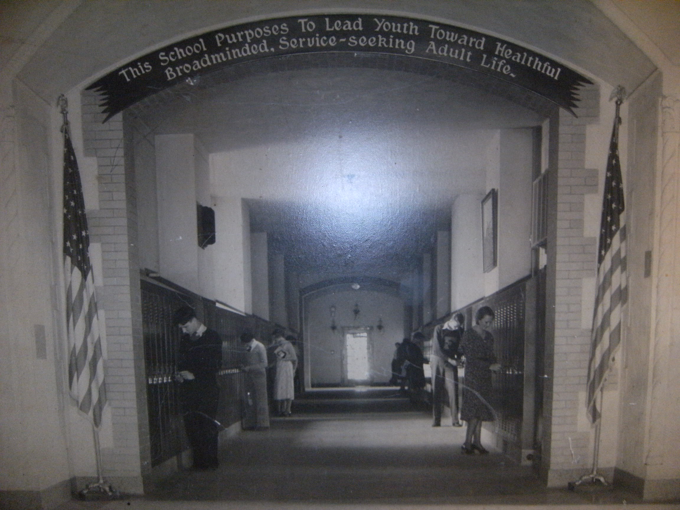Prior to the addition.  Maybe late 1930's. Archway banner displays the school motto.