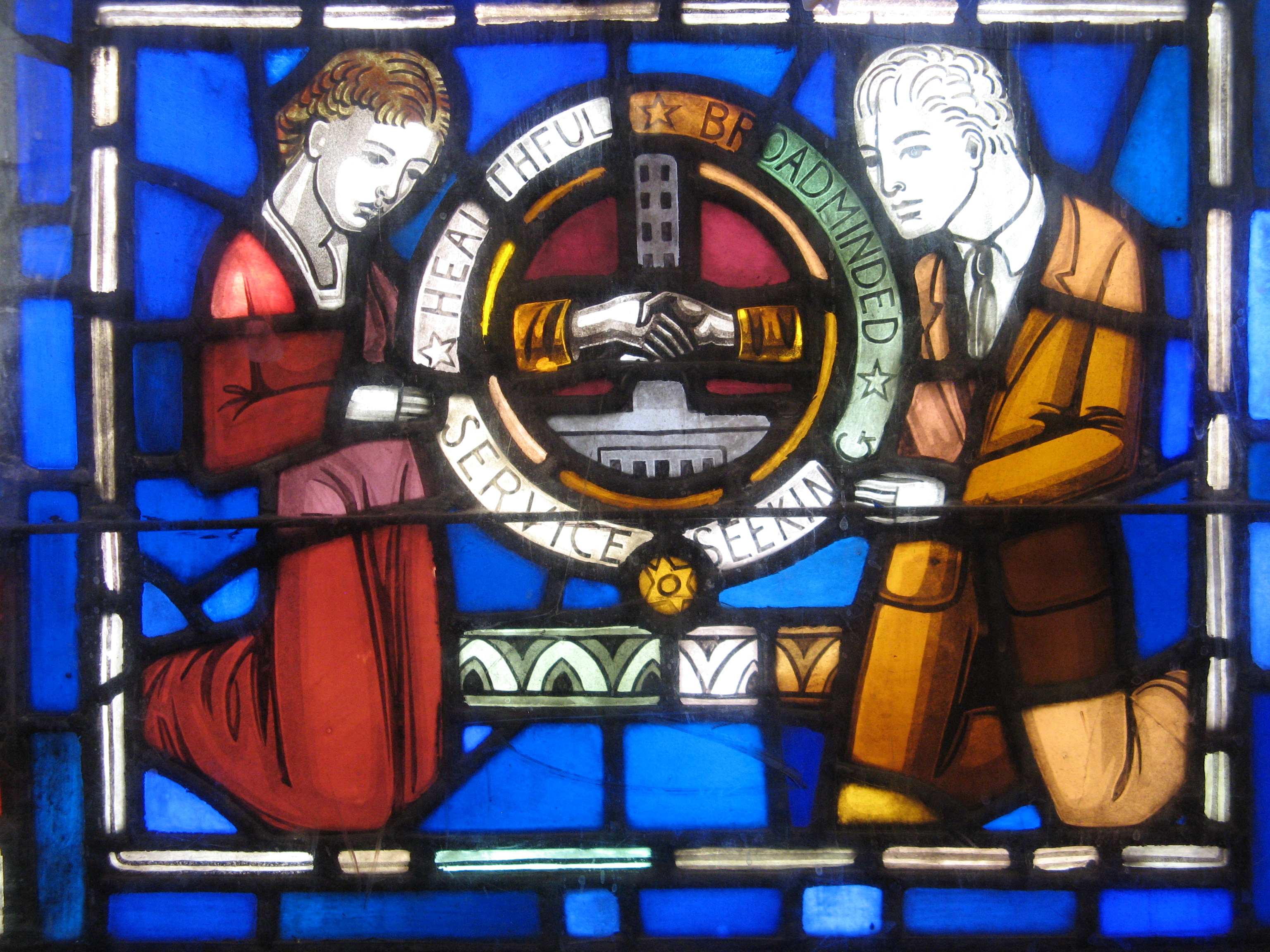 Above is a section of the Art Deco style stained glass window by Robert and Gertrude Metcalf, showing our Fairview High School motto and the tower from the original Fairview located at Catalpa and Fairview. 
