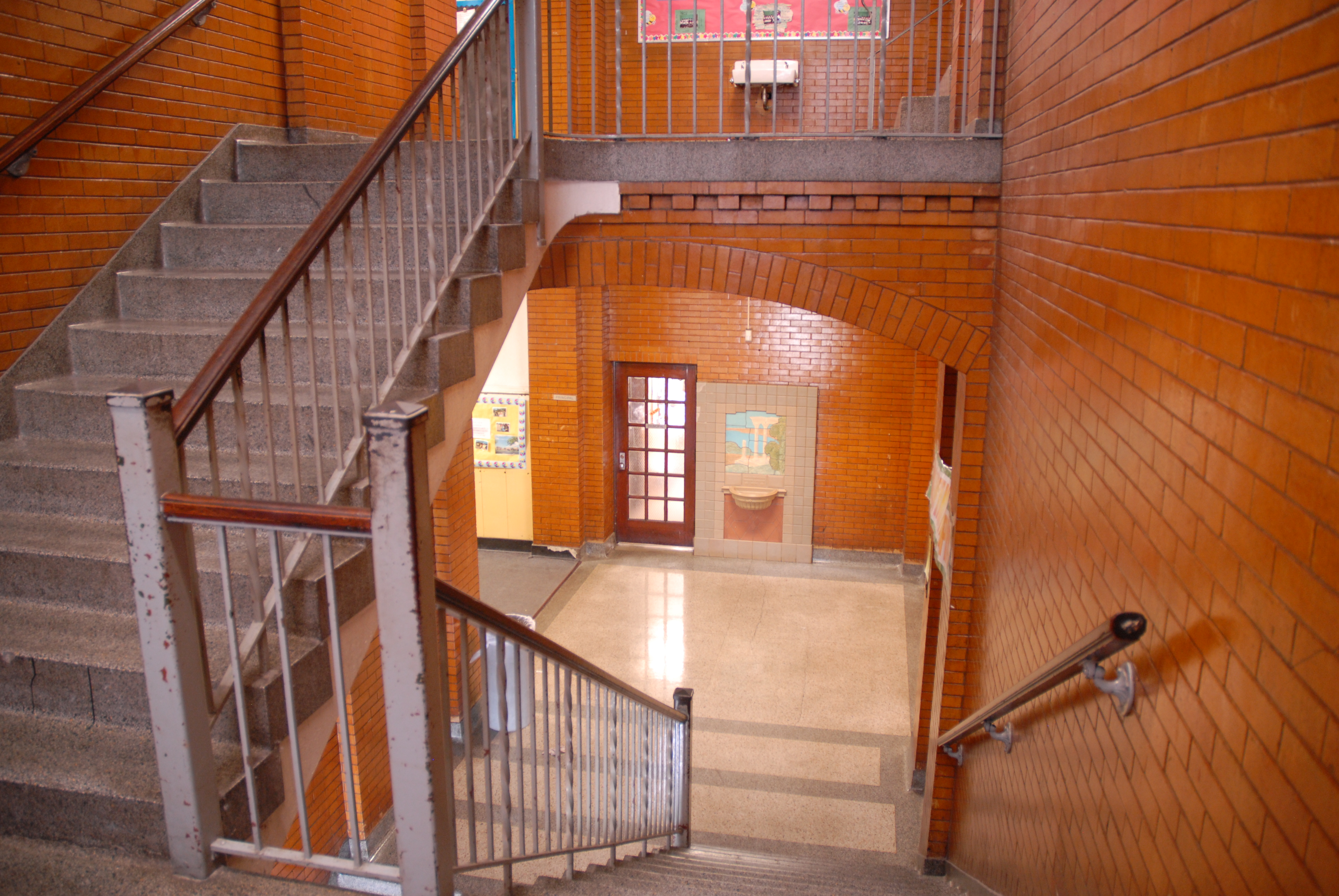Remember running to your next class up these steps? This is the center stairwell of FHS facing Hillcrest. The Longnecker-Folger Rookwood Fountain can be seen under the archway as it stood during our years at Fairview. Photo by Robert Hauff, FHS '63.