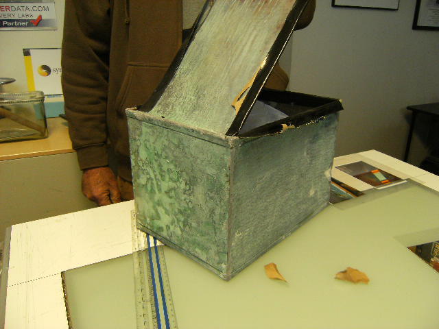 The Fairview Time Capsule was tightly sealed and constructed  of copper and tinned on the inside. Cutting the seal on the box created rough edges which have been protected with tape.  The box measures approximately 10