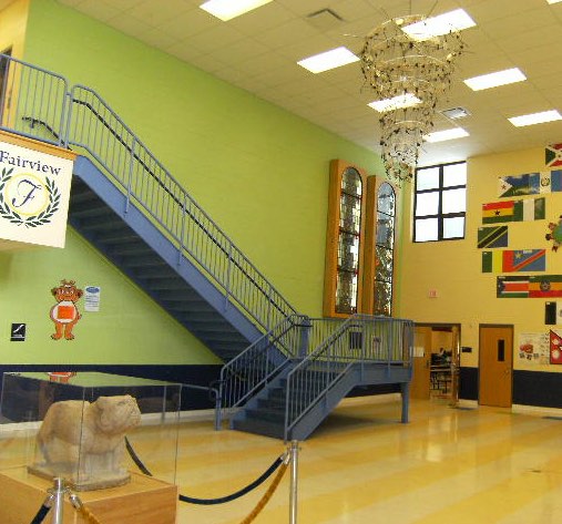 Lobby of new FPK school showing the Metcalf stained glass, new bronze plaque (obsured in this photo by the stairway) and Bruiser our Fairview High Bulldog Mascot.
